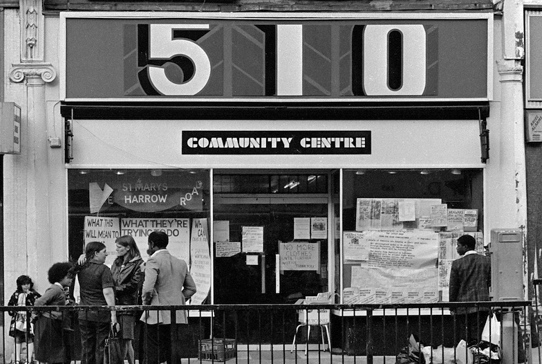 Group of people standing outside shop with Facia 510 Community Centre